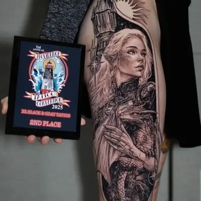 Tattoo of an elf woman with a dragon and castle on thigh.