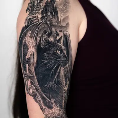 Black and grey tattoo of a horned cat with a gothic castle.