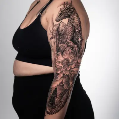 Tattoo of a dragon with floral and landscape elements on the upper arm.