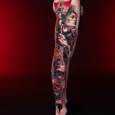 A full leg tattoo with a dramatic, detailed scene including a winged figure and face.