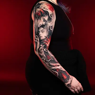 Tattoo sleeve with black and red portrait and abstract design.