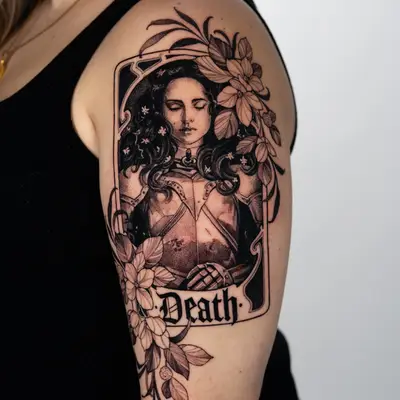 Person's upper arm tattoo of a woman with flowers and the word 'Death'.