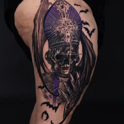 Intricate tattoo of a skull with papal regalia and bats on the thigh.