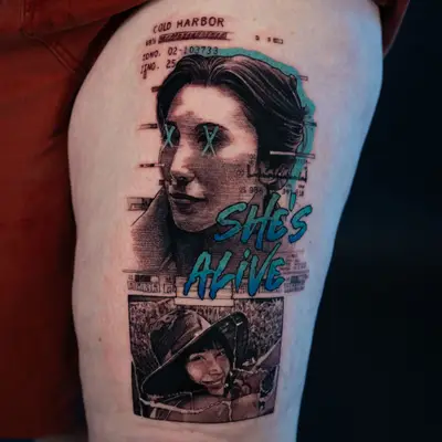 Premade tattoo on the thigh, inspired by the popular series Severance, with X marks over the eyes under the heading COLD HARBOR and a 68 percent progress bar, with teal and blue glitch bands, the words SHE'S ALIVE, and a cracked photograph of the same woman in a wide-brimmed hat below.