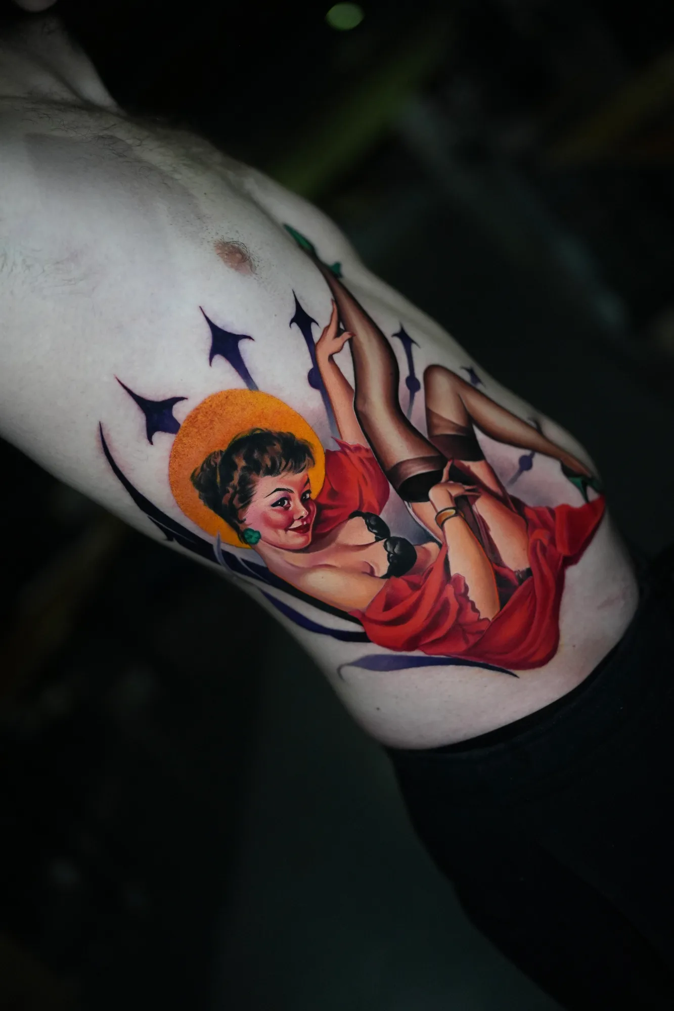 Colorful pin-up girl tattoo on rib cage.