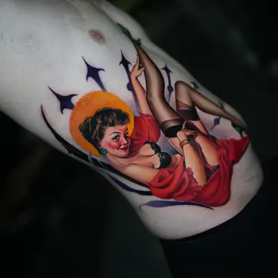 Colorful pin-up girl tattoo on rib cage.