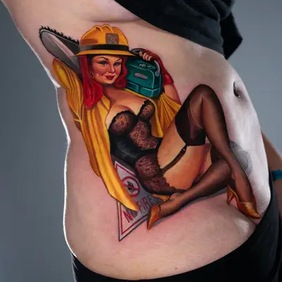 Tattoo of pin-up woman with chainsaw and fire hat on side abdomen.