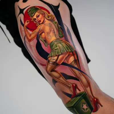 Colorful pin-up tattoo of a woman in military attire on the arm.