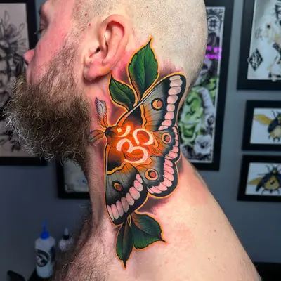 Colorful butterfly tattoo on the neck with green leaves and orange accents.