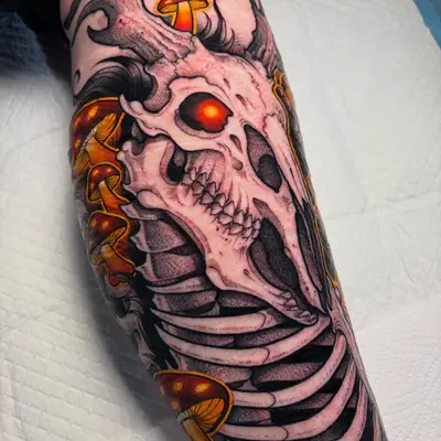 A detailed tattoo of a skull intertwined with mushrooms on the forearm.