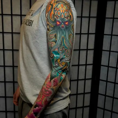 Colorful full sleeve tattoo featuring an octopus and other mythological elements.
