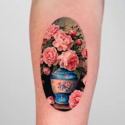 Tattoo of a blue vase with pink roses on an arm.