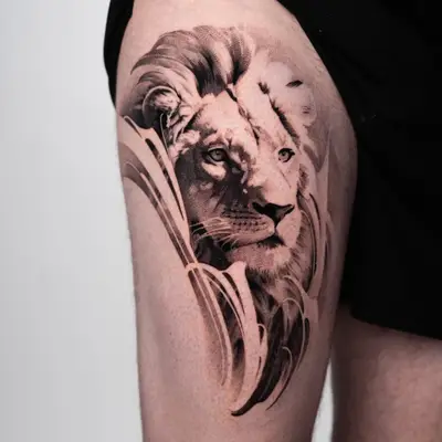 Tattoo of a lion's head on thigh in black and grey style