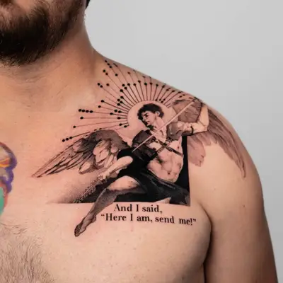 Tattoo of an angel with text 'Here I am, send me!' on man's chest.