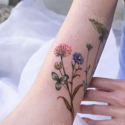 Tattoo of colorful wildflowers on forearm