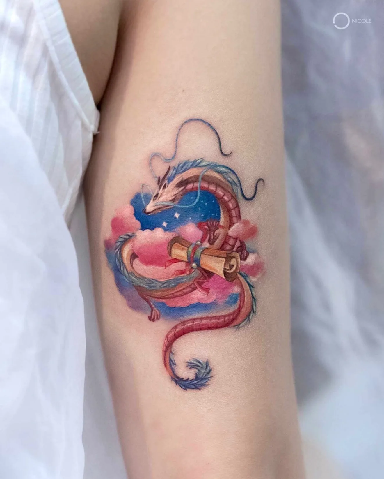 Colorful dragon tattoo with clouds and scroll