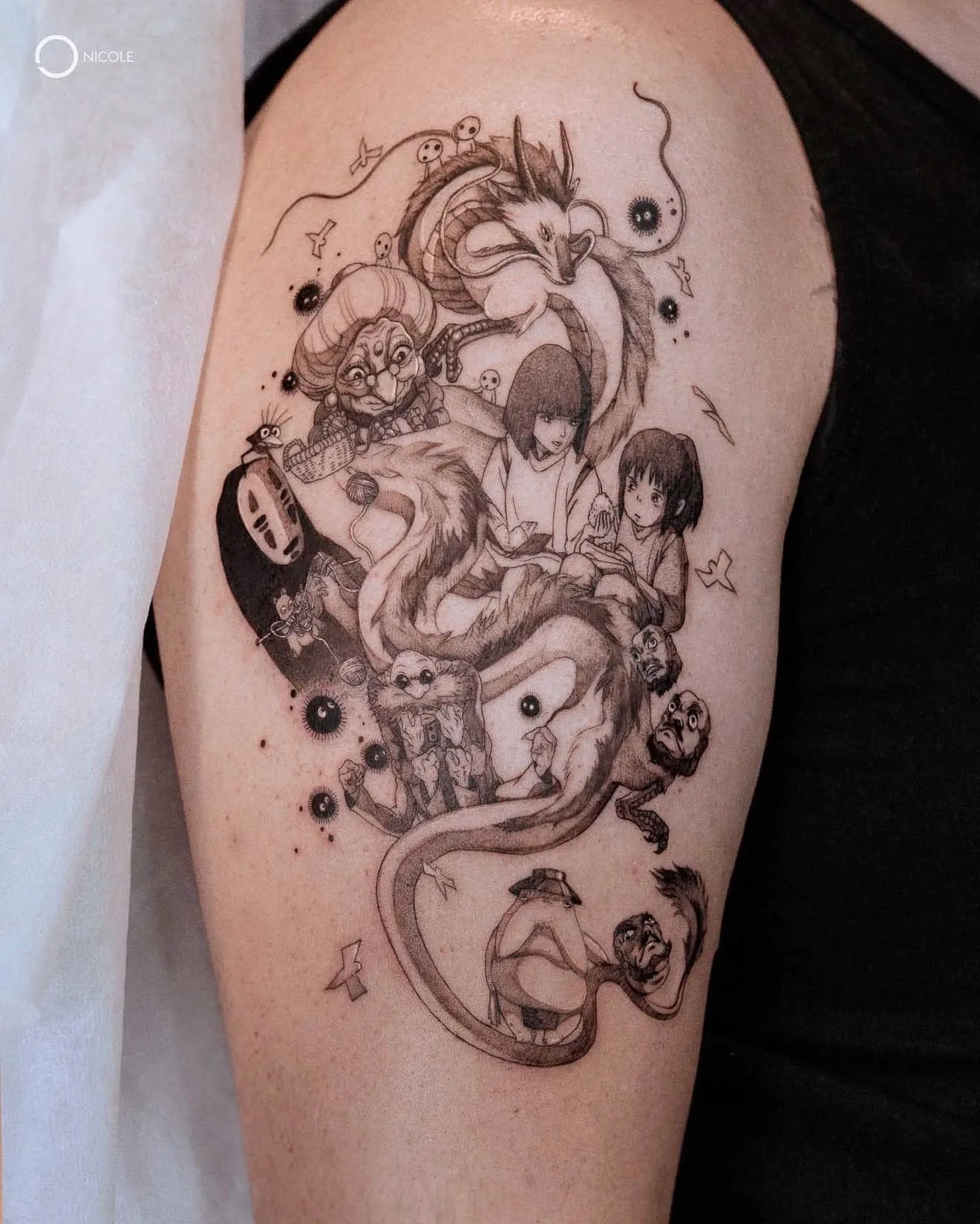 Tattoo depicting various anime characters in black and grey style on an arm.