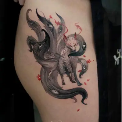Tattoo of a mythical nine-tailed fox with intricate tail designs on the thigh.