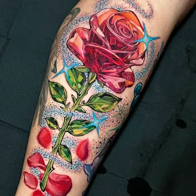Bright colorful rose tattoo with abstract elements on calf.