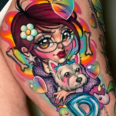 Color tattoo on a thigh of a cartoon girl in cat-eye glasses holding a small white dog, with glossy hearts, bones, a plush unicorn and a blue letter D around them on a rainbow background