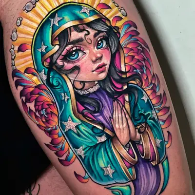 Tattoo of a stylized woman with colorful robes and hands in prayer.