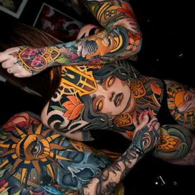 Colorful full-sleeve tattoos with traditional designs on arms and torso.