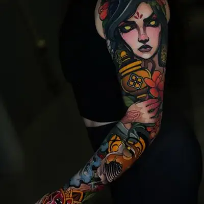 Colorful sleeve tattoo of a woman with flowers and lanterns.