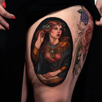 Tattoo of a woman in medieval attire holding an open book on the thigh.