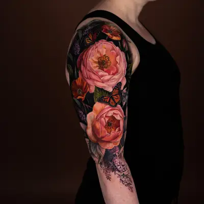 Colorful floral and butterfly tattoo on upper arm.