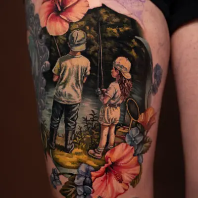 Tattoo of two children with fishing rods surrounded by flowers.