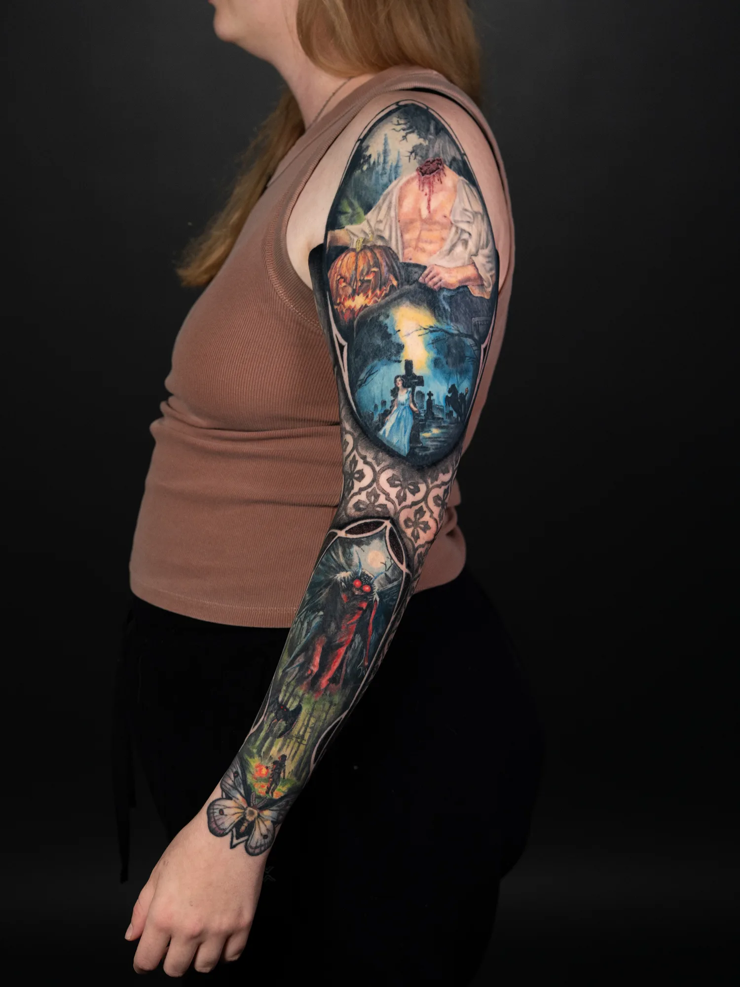Colorful sleeve tattoo with surreal and mythological scenes