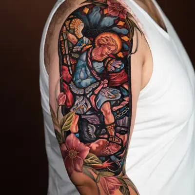 Colorful arm tattoo of an angel with floral and stained glass elements.