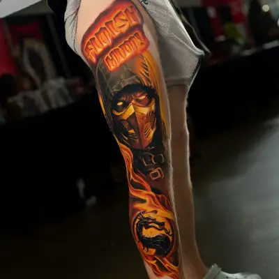 A vibrant tattoo of Scorpion with fire elements and the Moral Kombat logo..