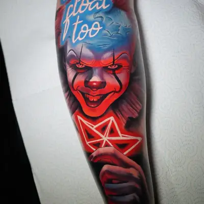 Tattoo of Pennywise on a calf holding a neon paper boat.