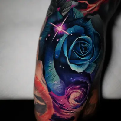 Tattoo of a blue rose in realism on the back of an arm.