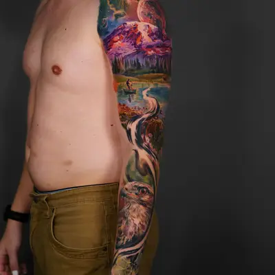 A colorful full sleeve tattoo featuring nature, wildlife, and space elements.