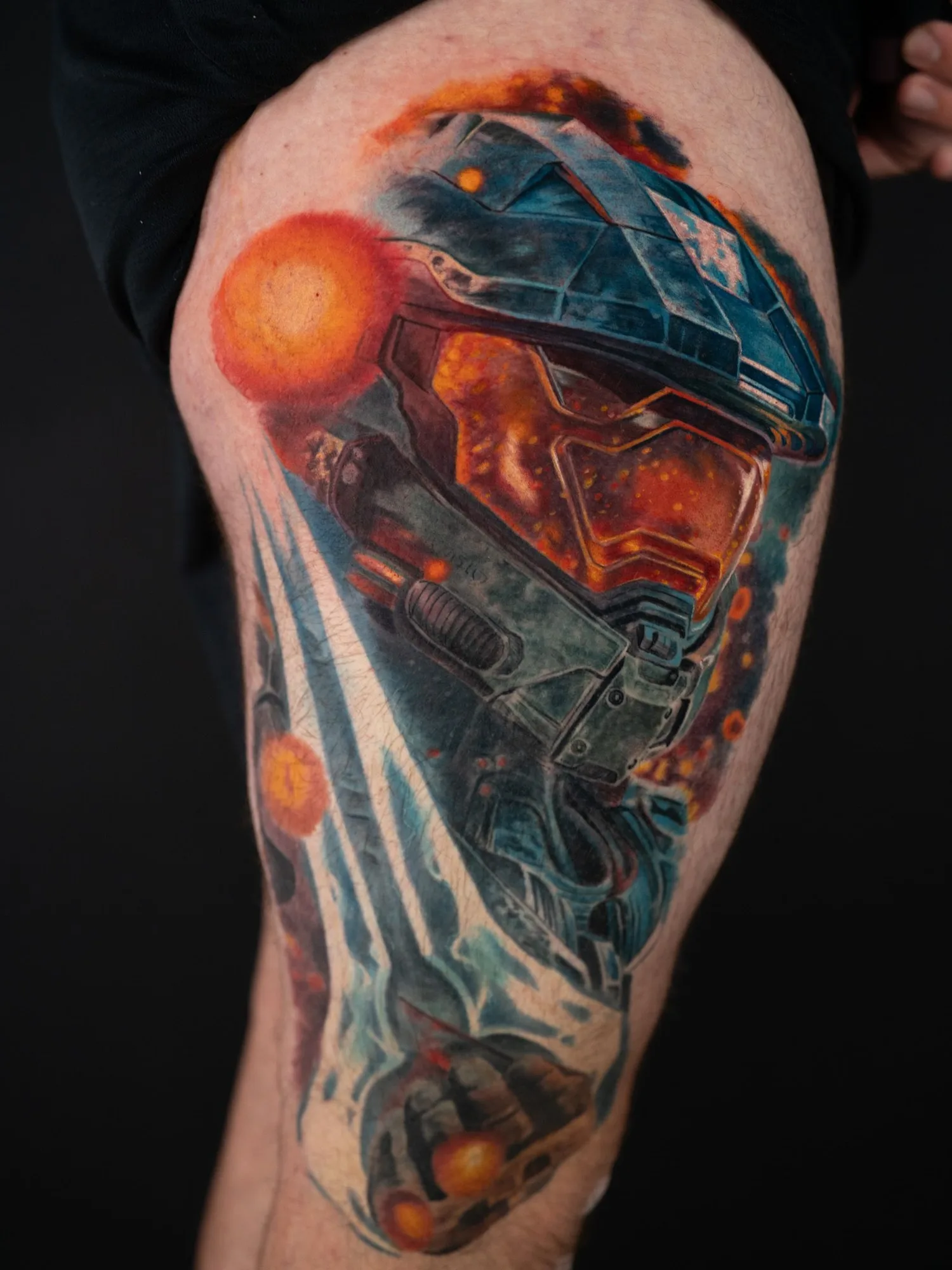 Color realism portrait tattoo of Master Chief holding an energy sword in a color realism style on a thigh.