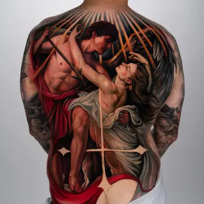 Tattoo depicting an embracing couple with draped fabrics and rays on a back piece.