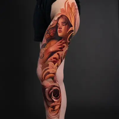 Colorful tattoo of a woman's face surrounded by roses and foliage on a leg.