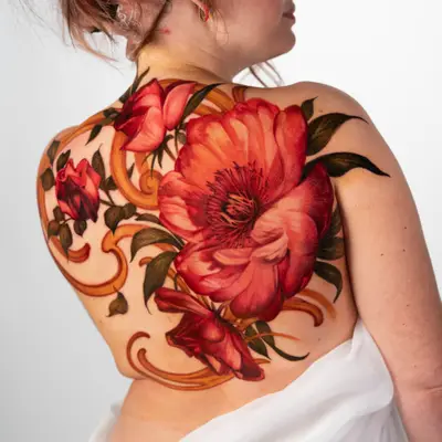 Colorful floral tattoo on woman's back.