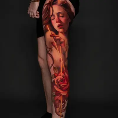 A vibrant tattoo of a woman and roses on a thigh, showcasing rich colors and painterly style.