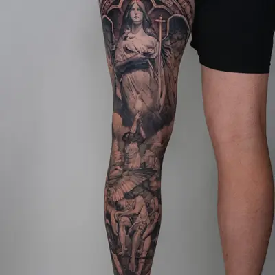 Full leg tattoo with angels and figures in black and grey.