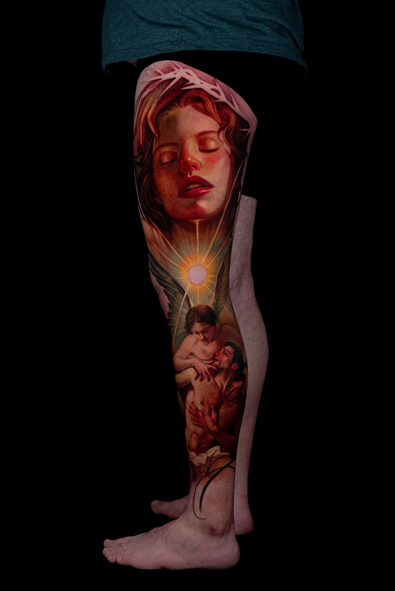 Tattoo of a painterly realism leg panel with a portrait and figures