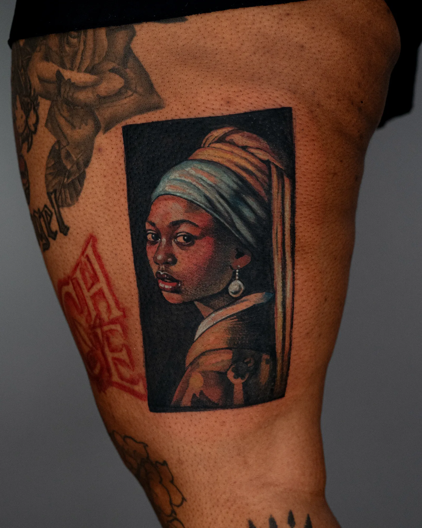Tattoo of Girl With a Pearl Earring with melanated skin 