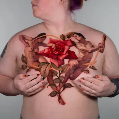 Chest tattoo with a rose and two nude figures.