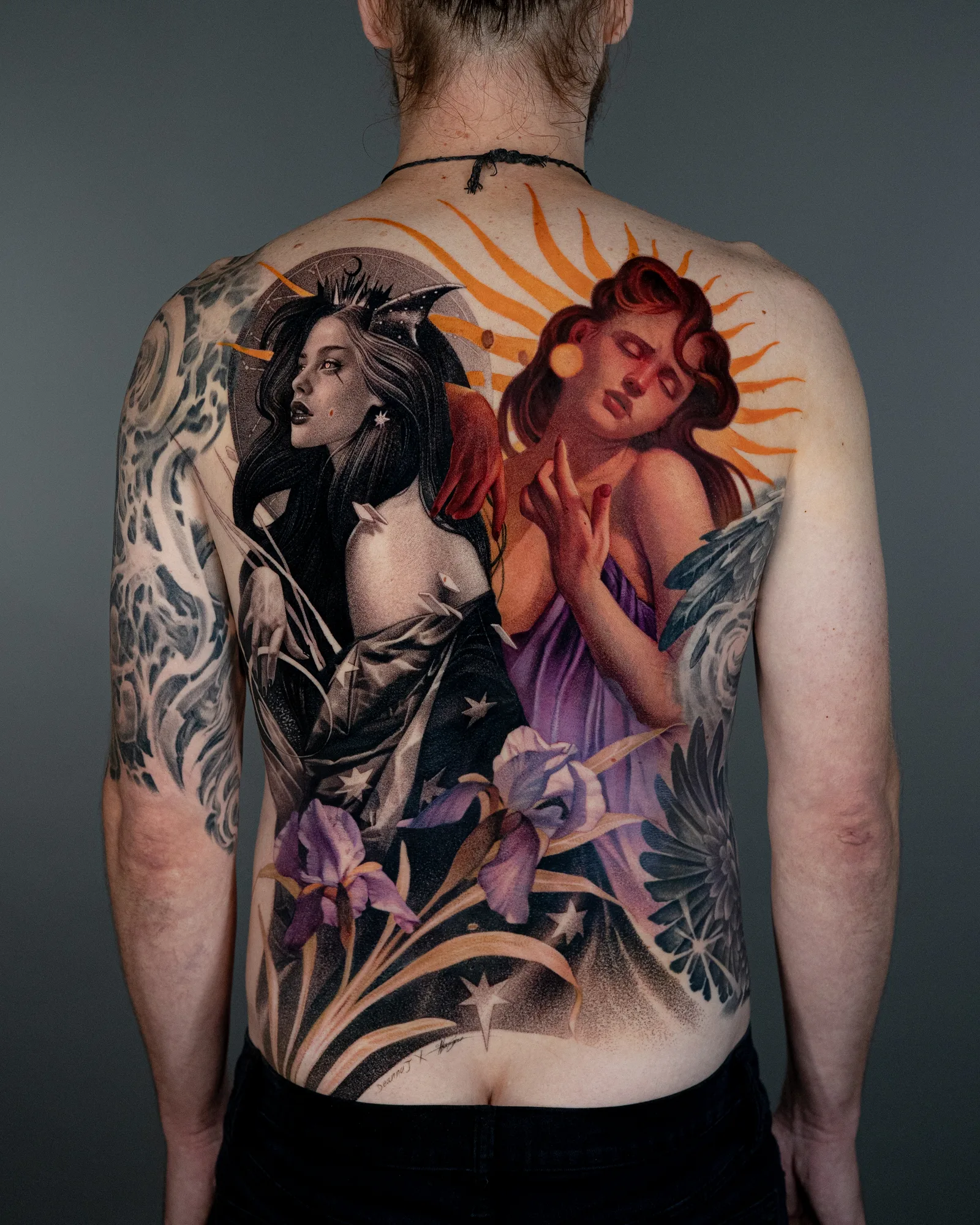 Tattoo featuring two ladies in black and grey and color with purple orchid flowers.