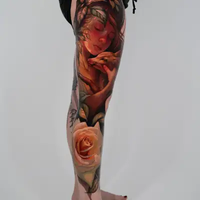 Full leg tattoo of a female figure caressing a deer and a yellow rose. 