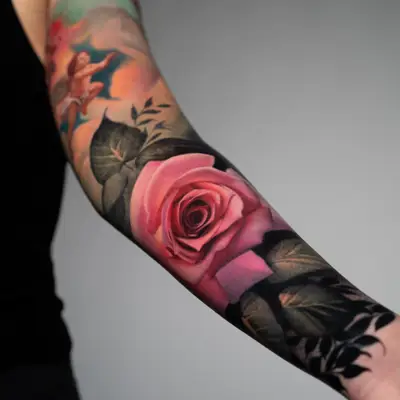 Painterly tattoo of a realistic pink rose on the forearm set on a dark background.