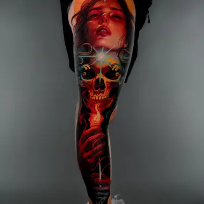 Colorful leg tattoo featuring a woman's face, skull, and candle.