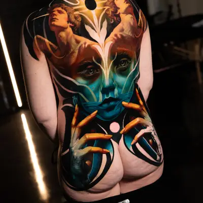 Full back piece tattoo done in a surrealism style with color, a portrait, hands, and women.